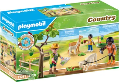 A Playmobil Country playset box showing figures, animals, and accessories in a farm-like setting.