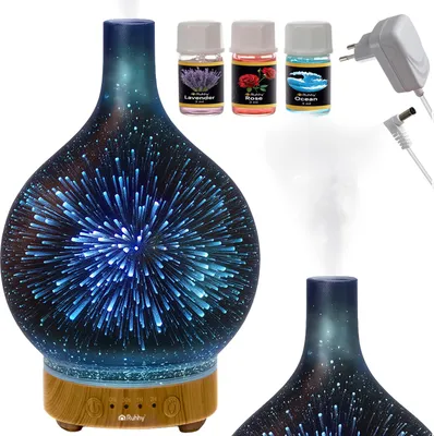 A product shot of an aroma diffuser with three small bottles of essential oils and a power adapter.