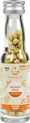 A glass bottle filled with small, light-colored tea balls, with a label on the front.
