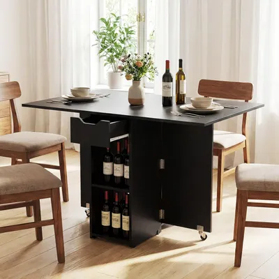A dining table with chairs set up in a room with natural light coming from a window.