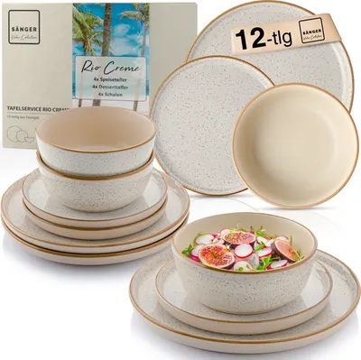 A set of stoneware dishes, including plates and bowls, is displayed with a salad in one of the bowls. The packaging for the set is also visible.