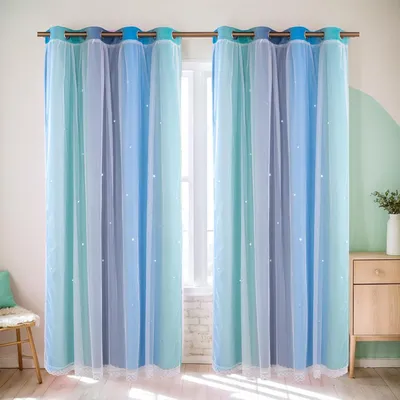 Two blue and teal gradient sheer curtains with white dots, hanging from a curtain rod in front of a window. A small wooden chair with a teal cushion is visible on the left, and a wooden cabinet with a white vase is on the right.