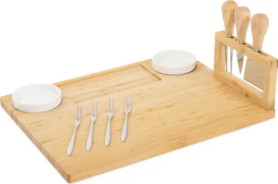 A bamboo cheese board set with two white ceramic bowls, four small forks, and a knife block with three cheese knives, presented on a white background.
