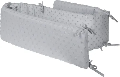 Two sections of a crib bumper are shown diagonally against a white background.