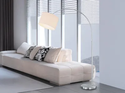 A modern living room with a white sofa and a floor lamp.