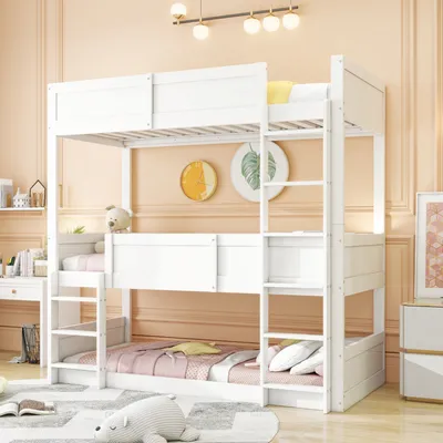 A white bunk bed with bedding and stuffed animals in a room with peach-colored walls.
