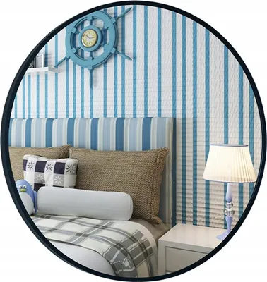 A bedroom scene with a bed, pillows, and a bedside table with a lamp.
