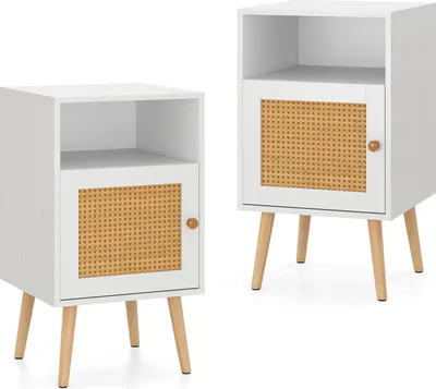 Two white nightstands with rattan cabinet doors and wooden legs are shown against a white background.