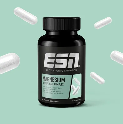 A bottle of ESN Magnesium Bisglycinate Complex capsules is shown against a light green background, with several loose capsules scattered around it.