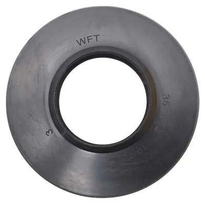 A black circular seal or gasket with text markings.