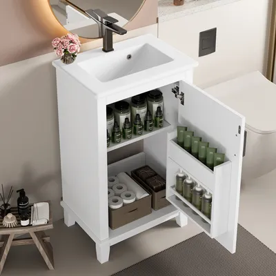 A white freestanding bathroom cabinet with an integrated ceramic sink and an open door revealing storage shelves with various toiletries and containers. A faucet is mounted on the sink, and a round mirror is visible in the background.