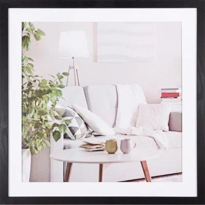 A living room scene with a sofa, coffee table, and plant.