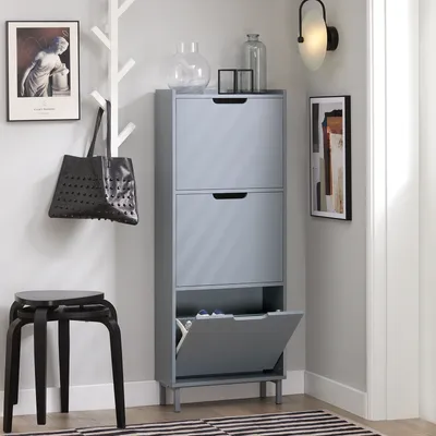 An entryway with a shoe cabinet, stool, and wall-mounted bag.