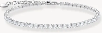 A close-up studio shot of a delicate silver bracelet with clear stones.