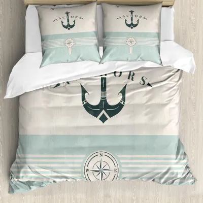 A top-down view of a nautical-themed duvet cover and pillowcases set on a bed.