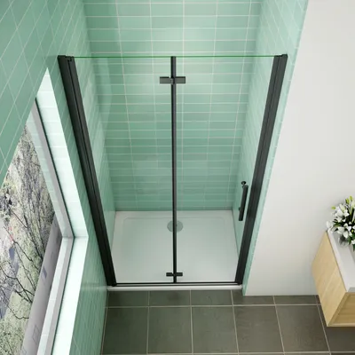 A modern bathroom with a black-framed glass shower enclosure.