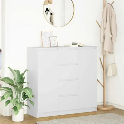 A white sideboard with drawers in a room with a plant and a coat rack.
