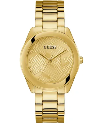 A close-up studio shot of a gold-colored Guess watch.