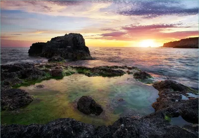 Produktbild von Wallario Fototapete Vliestapete, seidenmatte Oberfläche, einfache Verarbeitung, Größe 300 x 210 cm, Motiv Felsige Küste bei Sonnenuntergang
