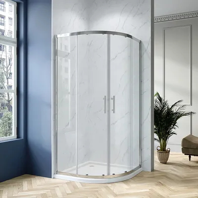 A modern bathroom with a curved glass shower enclosure.