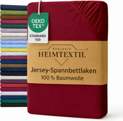 A stack of folded bed sheets in various colors is shown next to a single red bed sheet with a product label.