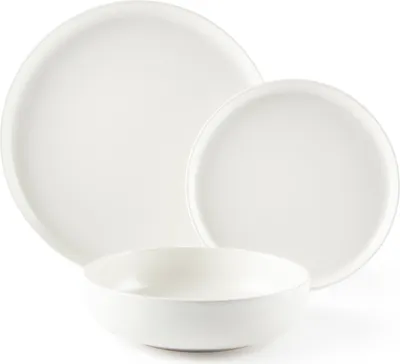 A set of white ceramic dishes, including a large plate, a smaller plate, and a bowl, arranged on a white background.