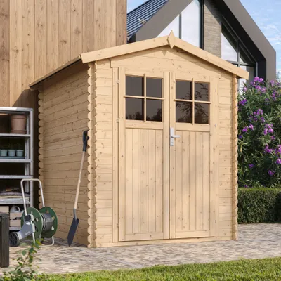 A wooden garden shed with double doors and windows, set in a garden with paving stones and greenery.