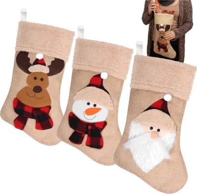 Three Christmas stockings with different designs (reindeer, snowman, Santa Claus) are displayed against a white background. A person is holding one of the stockings in the background.