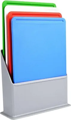 A set of four cutting boards in different colors (blue, red, white, green) stored in a gray stand.