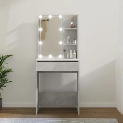 A vanity table with a mirror and lights, along with some toiletries, is shown in a room.