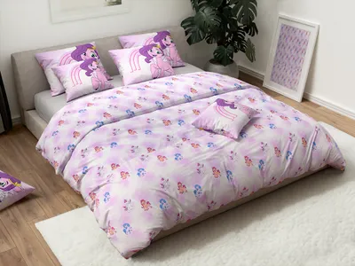 A bedroom scene with a bed made up with My Little Pony themed bedding.