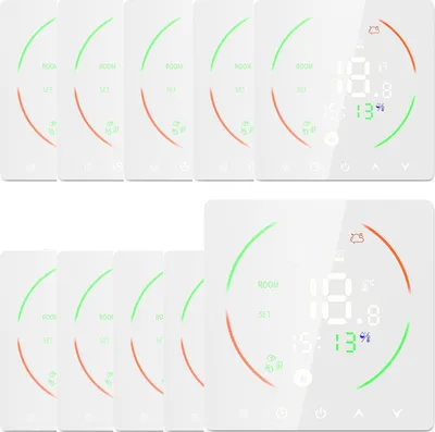 A collection of white digital thermostats arranged in two rows.