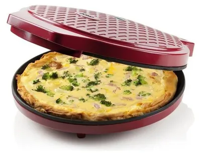 A red pizza maker with a quiche inside.