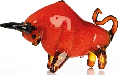 A glass sculpture of a red and orange bull.