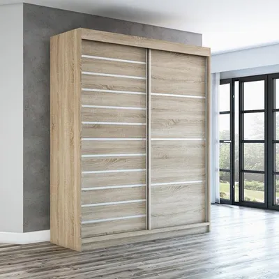 A modern sliding door wardrobe in a room with a concrete wall and wooden floor.