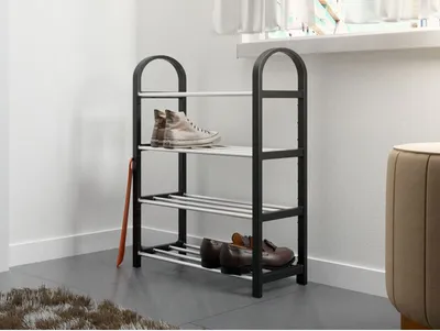 A shoe rack with shoes on it, placed in a room near a wall.