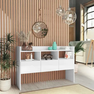 A white sideboard with decorative items and plants in a room with wood-paneled walls.