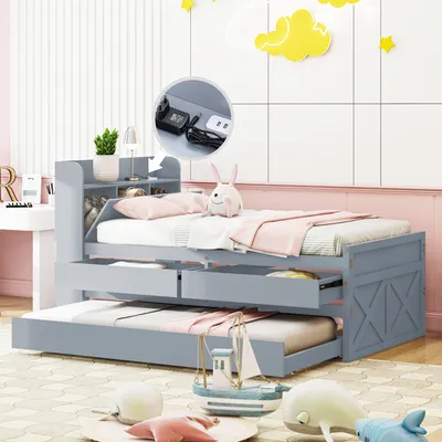A grey twin-sized daybed with a trundle and storage drawers, set in a child's bedroom with decorative clouds and stars on the wall.