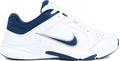 A side view of a white Nike shoe with navy blue accents.