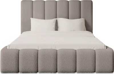 A bed with a headboard and footboard, made of bouclé fabric, with white pillows and bedding.