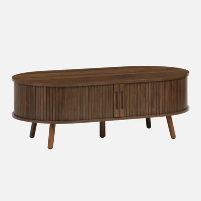 A wooden coffee table with ribbed detailing and two doors, presented against a plain background.