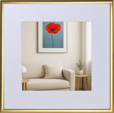 A framed picture of a red poppy on a wall above a sofa, with a small table and plant next to the sofa.