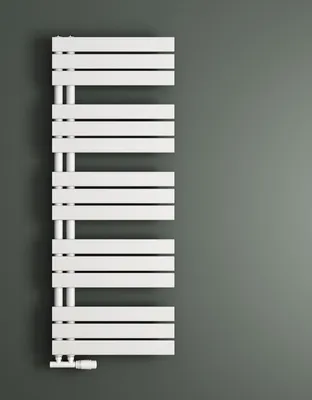 A white radiator is mounted on a gray wall.