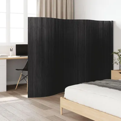 A room divider is placed between a desk area and a bed, suggesting a multi-functional living space.