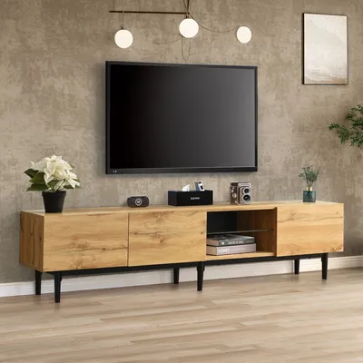 A modern living room with a TV stand and television.