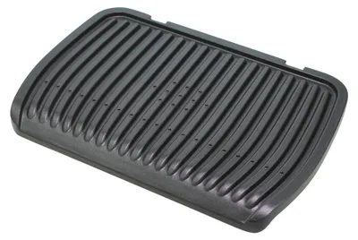 A black grill plate with raised ridges and small holes.