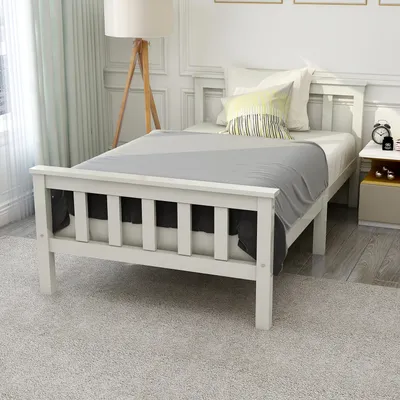 A white wooden single bed with a grey blanket and pillows in a bedroom setting.