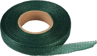 A roll of green garden tape on a cardboard core, with a length of tape unspooled.