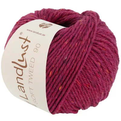 A ball of pink tweed yarn with multicolored flecks, with a label attached.