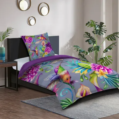 A bedroom scene with a bed featuring a hummingbird-themed duvet cover and pillow.